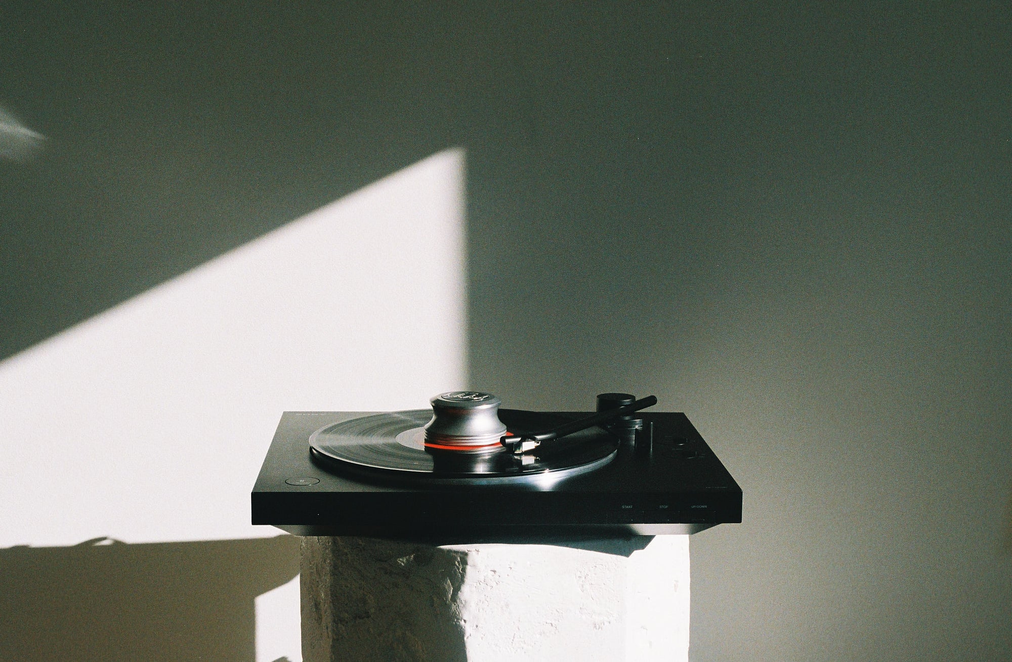 Precious Sound Record Stabilizer Beatles Edition on a record player in the sunlight